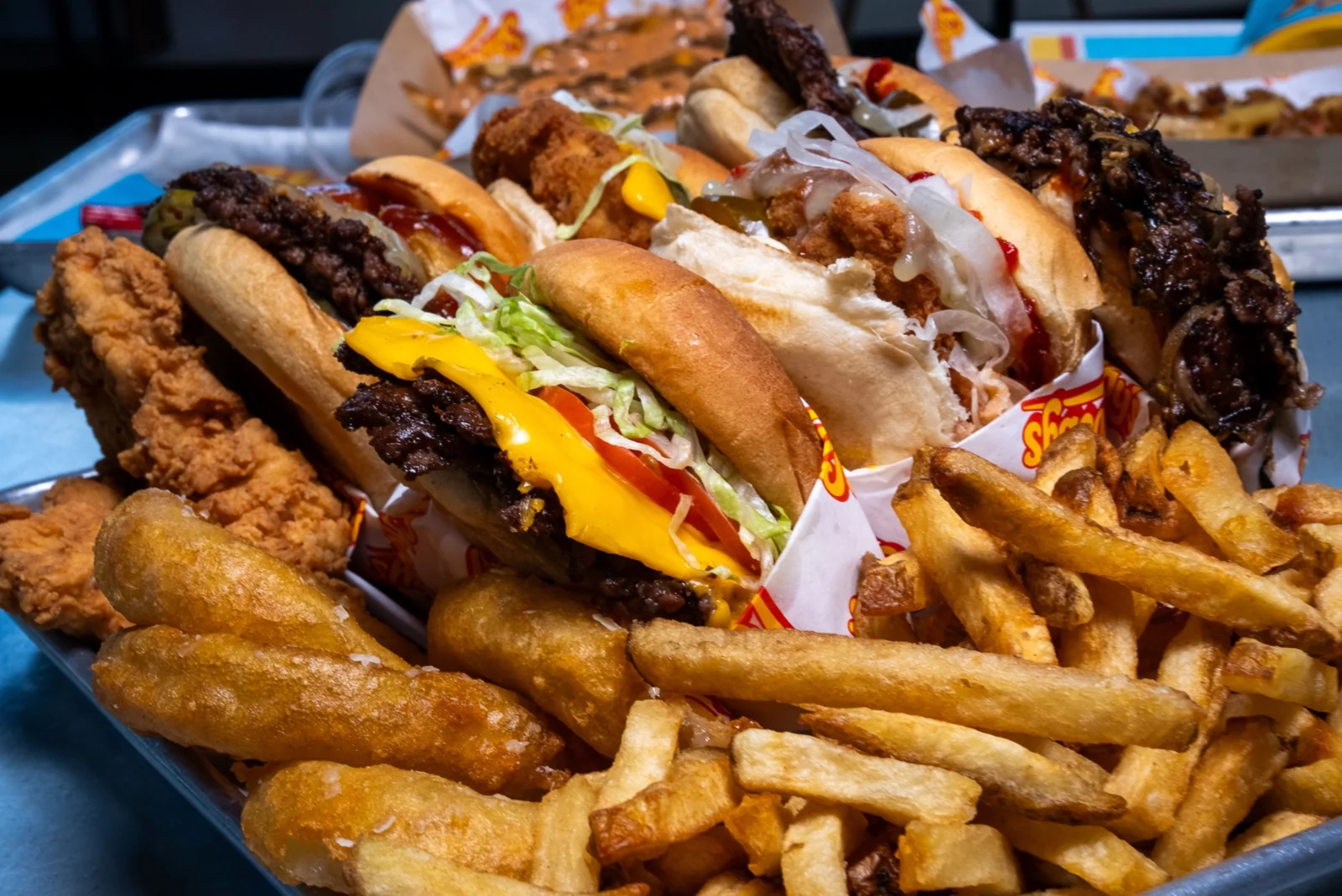 Juicy beef burgers with golden hand-cut fries, onion rings and crispy chicken tenders