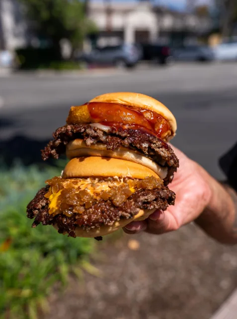 A lineup of three burgers with different toppings